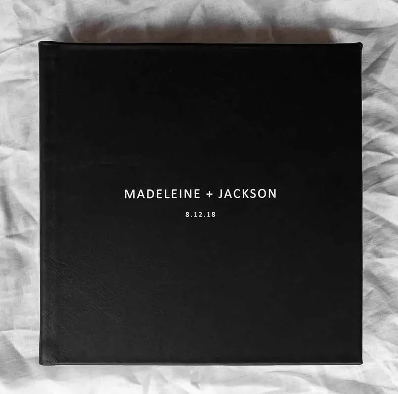 Square Photo Albums. Black leather photo album cover with white embossing perfect for a black & white wedding colour palette.
