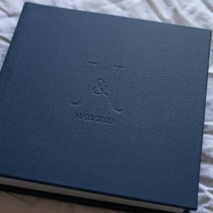 Square photo album for wedding photos with a leather cover in a navy blue colour and custom lettering