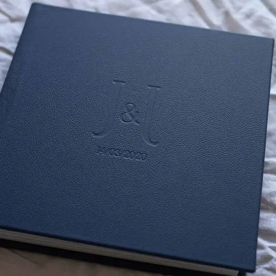 Square photo album for wedding photos with a leather cover in a navy blue colour and custom lettering
