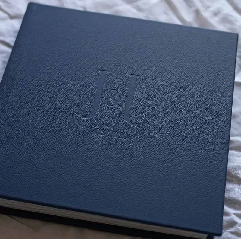 Square photo album for wedding photos with a leather cover in a navy blue colour and custom lettering