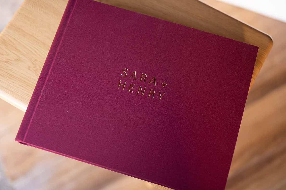 Deep red book cloth photo album cover perfect for a deep red wedding colour palette.