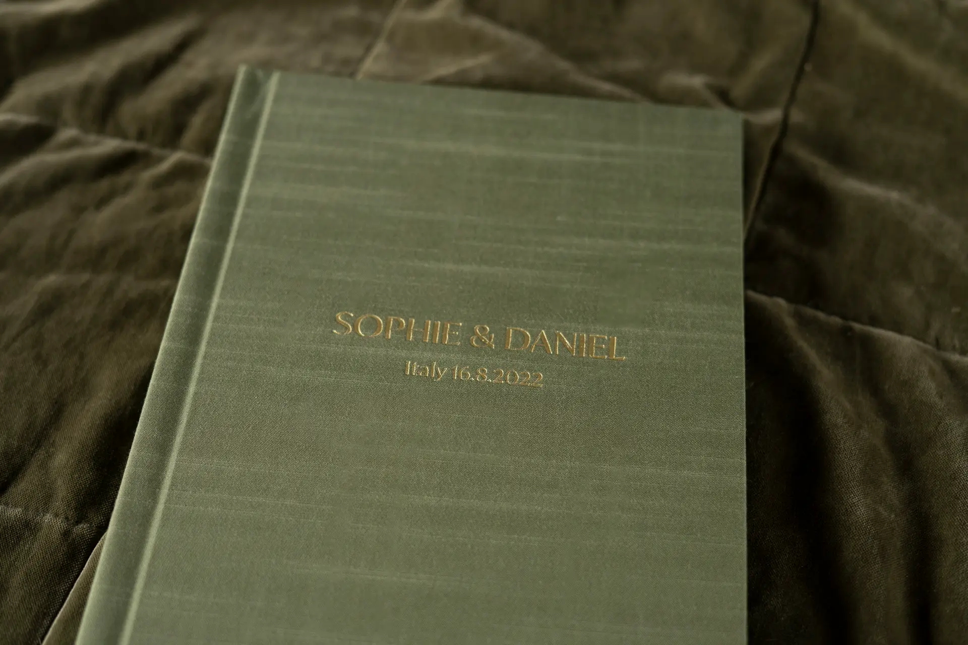 Coffee Table Wedding Album with Silk Book Cloth Cover in colour Olive in a portrait/vertical format photo album and personalised with gold foil embossing of the couples names, location and wedding date