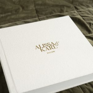 Australia's Best Photo Albums. This Wedding Album features a textured silk fabric cover in a natural colour (Silk Pearl) and Gold Foil embossing to personalise the cover with the couples names & wedding date on the front and Best Day Ever on the spine.