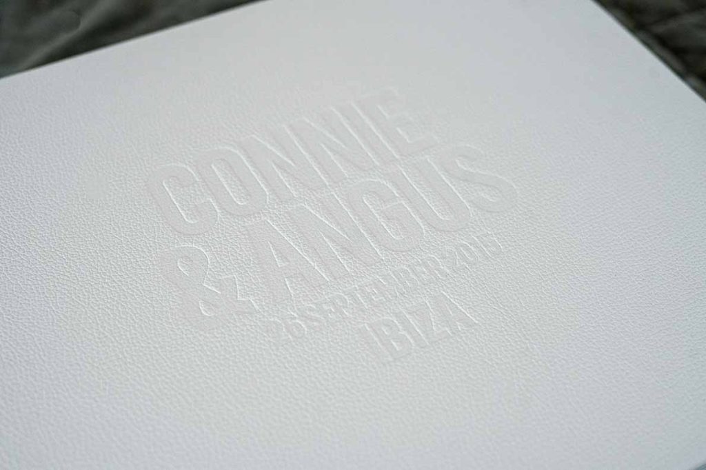Wedding album cover with large blind embossing on front cover in a classic white leather.